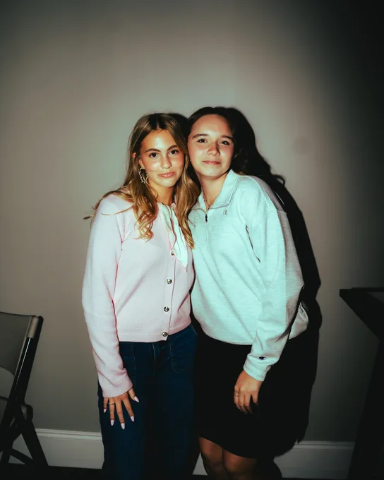 Two teenage girls side by side, smiling